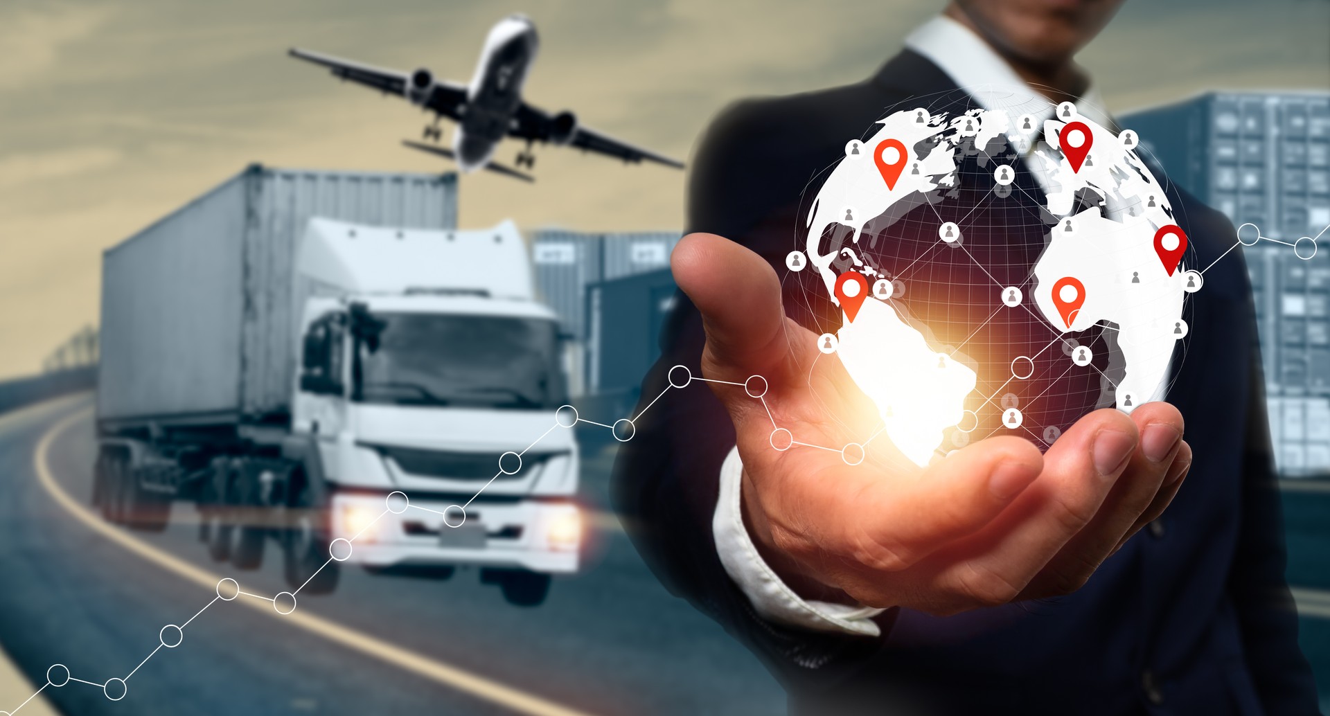 A businessman uses his hands on a logistic network distribution and smart transportation and networking intelligent logistics of truck and cargo, logistic import export and industry.